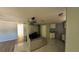 Open-concept living space with a mix of flooring and a partial view of kitchen at 39 S College Ave, Maitland, FL 32751