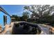 Features a murky pool surrounded by mature trees on a sunny day with a blue house nearby at 39 S College Ave, Maitland, FL 32751