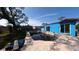 Shows a backyard pool with a distinctive shape and a blue house under a partly cloudy sky at 39 S College Ave, Maitland, FL 32751