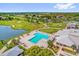 This aerial view of the community displays the neighborhood pool and lush golf course at 3926 Ventura Place, Orlando, FL 32822