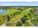 Scenic aerial view of lush green golf course with winding paths, lake, and beautiful landscaping at 3926 Ventura Place, Orlando, FL 32822