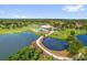 An aerial view shows the community clubhouse, golf course, and community pool area at 3926 Ventura Place, Orlando, FL 32822