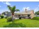 Lush backyard featuring a pool, screen enclosure, and well-maintained lawn at 3926 Ventura Place, Orlando, FL 32822