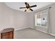 Neutral bedroom featuring a ceiling fan, large window, and carpeted floors at 3926 Ventura Place, Orlando, FL 32822