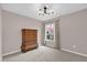 Neutral bedroom featuring a chandelier, large window, carpeted floors, and tan walls at 3926 Ventura Place, Orlando, FL 32822