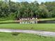 Manicured entrance to the Ventura community with water feature and lush tropical plants at 3926 Ventura Place, Orlando, FL 32822