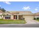 Charming single-story home featuring a tile roof, well-manicured lawn, and an attached two-car garage at 3926 Ventura Place, Orlando, FL 32822