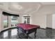 Game room with black marble floor, coffered ceiling, and a pool table, perfect for entertaining at 3926 Ventura Place, Orlando, FL 32822
