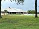 A view of the golf course and clubhouse features a lush green fairway and a water hazard at 3926 Ventura Place, Orlando, FL 32822