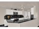 Modern kitchen featuring white cabinets, black countertops, and stainless steel appliances at 3926 Ventura Place, Orlando, FL 32822