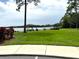 Community lakeside park with grassy area, picnic tables, and grill at 3926 Ventura Place, Orlando, FL 32822