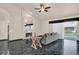 Cozy living room with a fireplace, black marble floors, and sliding glass doors leading to the pool at 3926 Ventura Place, Orlando, FL 32822