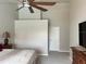 A view of the bedroom with white walls, ceiling fan, and access to a door at 3926 Ventura Place, Orlando, FL 32822