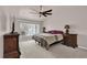 Spacious bedroom with ceiling fan, carpet floors, and well-lit ambiance from the large window at 3926 Ventura Place, Orlando, FL 32822