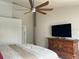 Bright bedroom with vaulted ceilings, ceiling fan, and dark wood dresser at 3926 Ventura Place, Orlando, FL 32822