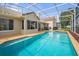 Sparkling pool with expansive patio area, screen enclosure, and lush landscaping at 3926 Ventura Place, Orlando, FL 32822