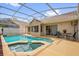 A screened-in pool and spa highlight the backyard, perfect for relaxing or entertaining at 3926 Ventura Place, Orlando, FL 32822