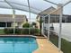 A partially-view of the screen-enclosed pool provides backyard enjoyment at 3926 Ventura Place, Orlando, FL 32822