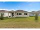 Expansive backyard with covered patio, offering ample space for outdoor activities at 4223 Little Owl Ln, Kissimmee, FL 34746