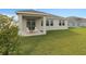 Spacious backyard featuring a covered patio and well-maintained lawn at 4223 Little Owl Ln, Kissimmee, FL 34746