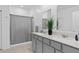 Bright bathroom features a double sink vanity, quartz countertop, and a shower with a curtain at 4223 Little Owl Ln, Kissimmee, FL 34746