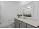 Bright bathroom featuring a granite vanity, framed mirror, and decorative shower curtain at 4223 Little Owl Ln, Kissimmee, FL 34746