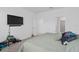 Clean bedroom with a TV, neutral colors, and carpet flooring, offering a tranquil space to unwind at 4223 Little Owl Ln, Kissimmee, FL 34746