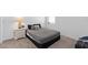 Comfortable bedroom with gray carpet, a full-sized bed, a nightstand, and a neutral color scheme at 4223 Little Owl Ln, Kissimmee, FL 34746