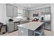 Modern kitchen with stainless steel appliances, gray cabinetry, and a quartz countertop island at 4223 Little Owl Ln, Kissimmee, FL 34746