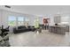 Open living area featuring a tiled floor, large windows, and an adjacent dining space at 4223 Little Owl Ln, Kissimmee, FL 34746