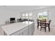 Bright, open-concept living space featuring a modern kitchen island and a cozy seating area with natural light at 4223 Little Owl Ln, Kissimmee, FL 34746