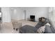 Well-lit living room with tiled floor, sectional sofa, and television setup at 4223 Little Owl Ln, Kissimmee, FL 34746
