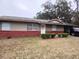 Charming single-story home featuring brick accents and a well-maintained front lawn at 4225 Ne 25Th Ave, Ocala, FL 34479