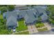 An aerial view of townhomes with green roofs and manicured lawns on a sunny day at 4545 Southfield Ave, Orlando, FL 32812