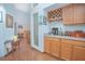 Stylish bar area with a wine rack, granite countertops, and wood cabinets at 4545 Southfield Ave, Orlando, FL 32812