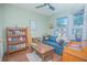 Inviting bedroom with natural light, a bookcase, and a comfortable blue sofa at 4545 Southfield Ave, Orlando, FL 32812