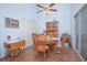 Bright dining room with a wooden table and chairs, featuring wood floors and plenty of natural light at 4545 Southfield Ave, Orlando, FL 32812