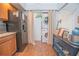 Kitchen area with black appliances, wood cabinets, laundry area, and dining nook at 4545 Southfield Ave, Orlando, FL 32812
