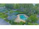 Aerial view of a community pool with surrounding greenery and amenities at 4545 Southfield Ave, Orlando, FL 32812