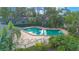 Community pool surrounded by lush landscaping, offering a refreshing outdoor amenity at 4545 Southfield Ave, Orlando, FL 32812