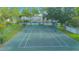 Aerial view of community tennis court surrounded by lush landscaping and trees at 4545 Southfield Ave, Orlando, FL 32812