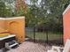 Fenced backyard with a patio, hot tub and a manicured lawn, perfect for outdoor relaxation and entertainment at 4778 Vero Beach Pl, Kissimmee, FL 34746