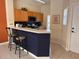 Eat-in kitchen featuring breakfast bar, appliances, wooden cabinets and an open concept, great for modern living at 4778 Vero Beach Pl, Kissimmee, FL 34746