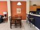 Spacious living area open to the kitchen and dining area, featuring sleek counters and an inviting ambiance at 4778 Vero Beach Pl, Kissimmee, FL 34746