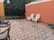 Brick patio showing outdoor seating with three white chairs at 4778 Vero Beach Pl, Kissimmee, FL 34746