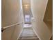 Well-lit stairway with carpeted steps, providing a safe and comfortable transition between floors at 4778 Vero Beach Pl, Kissimmee, FL 34746