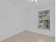 Empty bedroom with tiled floor, ceiling fan, white walls, and a bright window at 517 Ivanhoe Way, Casselberry, FL 32707
