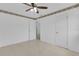 Unfurnished bedroom with tiled floors, ceiling fan, and two access doors at 517 Ivanhoe Way, Casselberry, FL 32707