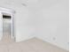 Unfurnished bedroom with tiled floor, ceiling fan, white walls, and an open doorway at 517 Ivanhoe Way, Casselberry, FL 32707