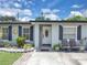 Charming home featuring a decorative sun accent and a welcoming white front door at 517 Ivanhoe Way, Casselberry, FL 32707